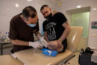 34-летний Александр Савченко на приеме у врача. Александр лишился обеих ног на фронте, когда в мае Россия обстреляла украинскую военную базу в Донецкой области