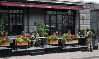 Wagner fighters relax on the terrace of a restaurant on Budonnovskiy Avenue.