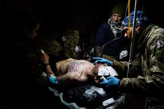 Украинские военные врачи оперируют раненого бойца ВСУ в полевом госпитале рядом с Бахмутом