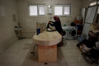 Hatice, 43, goes to do laundry at the Cankaya cemetery morgue