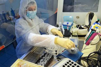 An employee for the Hygiene and Epidemiology Center in Krasnodar Krai processes biological samples to determine whether or not they contain the new coronavirus.