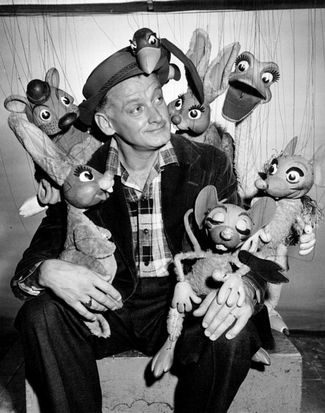 American actor Art Carney and the puppets from the TV show 