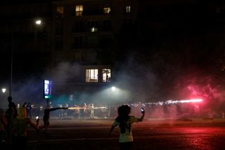 Paris Saint-Germain fans set off fireworks on Avenue Foch in Paris