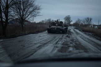 Бойцы ВСУ едут на бронетехнике по дороге недалеко от линии фронта