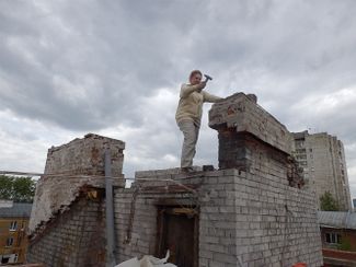 Anastasia Maltseva on the roof of her building during the renovation.