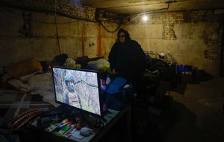 A local resident, 80-year-old Galina Garmati, is downstairs next to Russia's state television broadcast channel