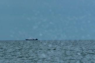 A Russian coast guard ship in the Sea of Azov (view from a Ukrainian coast guard ship), April 2021. At the time, tensions appeared to be easing and by the end of April, the situation had more or less returned to the status quo. Experts speculated that Russia had massed troops along the Ukrainian border as a show of strength directed at U.S. President Joe Biden ahead of talks with Vladimir Putin.
