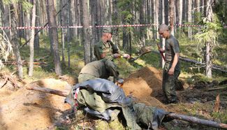 The Russian Military Historical Society excavates bodies from the Sandarmokh forest, August 29, 2018