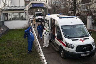 Disinfecting an ambulance after offloading a patient with coronavirus symptoms at Moscow’s University Clinical Hospital No. 4 on April 9, 2020