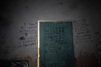 The residents of Yahidne marked the days they were held captive on the basement’s door. To the right of the door they recorded the names of those who died in the basement — to the left, they recorded the names of those who were shot by Russian troops. April 12, 2022. 
