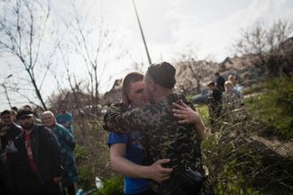 Украинский солдат обнимает своего друга, сражающегося на стороне пророссийских сепаратистов в Краматорске