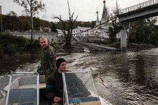 Офицеры Национальной гвардии на реке Северский Донец. Они переправляют мирных жителей с одного берега реки на другой