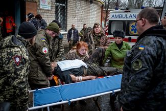 Medics carry a wounded Ukrainian soldier inside Artemovsk hospital.