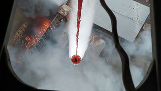 A helicopter drops water on the blaze at the Nevskaya Manufaktura