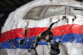 Judges and lawyers in the trial of three Russians and a Ukrainian charged in the 2014 downing of MH17 visit the plane’s wreckage at a Dutch military airbase on May 26, 2021
