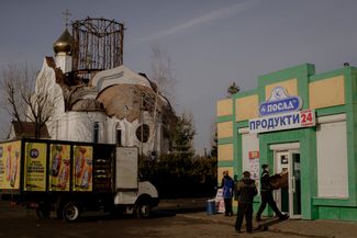 The destroyed Church of Faith, Hope, Love and the Mother Sophia. The foundation of the current church was laid in 2010, and it was completed in 2019. The grocery store shows traces of the former signboard written in Russian. December 30, 2023.