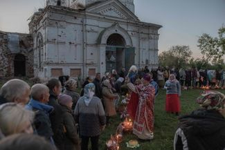 Easter celebrations outside of the Ascension Church in Lukashivka, a village in Ukraine’s Chernihiv region. Lukashivka was under Russian occupation from March 9–30, 2022. The Ascension Church, which was constructed in the early 20th century, was damaged during the hostilities. Eyewitnesses <a href="https://hromadske.ua/ru/posts/v-sele-polnostyu-unichtozheny-32-doma-povrezhden-kazhdyj-kak-zhivet-lukashovka-cherez-god-posle-osvobozhdeniya" rel="noopener noreferrer" target="_blank">told</a> the Ukrainian news outlet Hromadske that Russian soldiers used the church to store ammunition and killed civilians on its grounds. 