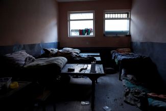 Кровати в оборудованной российской армией пыточной камере в Купянске
