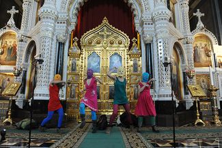 Masked members of Pussy Riot perform during their flashmob-style protest inside Moscow's Cathedral of Christ the Savior. February 21, 2012.