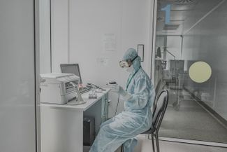 A doctor analyzes samples in the corridor of the intensive care unit
