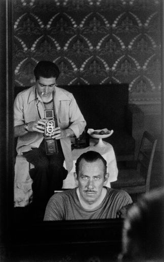 John Steinbeck and Robert Capa captured in the reflection of a mirror. USSR, September 1947.