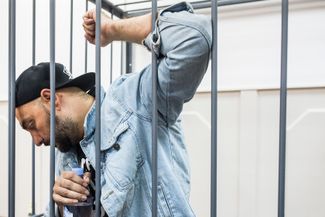 Кирилл Серебренников в клетке для подсудимых в здании суда