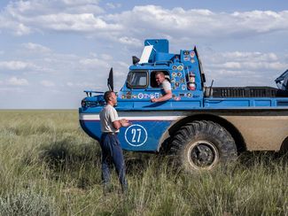 A search and rescue team waits for a Soyuz MC-01 unit to reenter Earth’s atmosphere. This all-terrain vehicle from a Bluebird search unit is designed to search for and transport spaceships after landing even in unfavorable weather conditions. Kazakhstan, June 2015