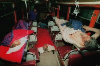 Survivors receiving first aid in a mobile hospital unit.
