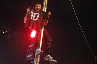 A Paris Saint-Germain fan in Paris celebrates the team's Champions League victory