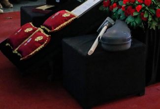 Кувалда и футляр от скрипки, которые используются как символы ЧВК Вагнера, у гроба Владлена Татарского