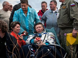Russian cosmonaut Gennady Padalka enjoys an apple after returning to Earth on a SoyuzTMA-17M spacecraft. Fresh produce is a rarity on the ISS, so cosmonauts and astronauts are often treated to fruits and vegetables when they land. Padalka is the world record holder for the total amount of time spent in space by one person; he has been away from the blue marble for a total of 878 days. Kazakhstan, September 2015