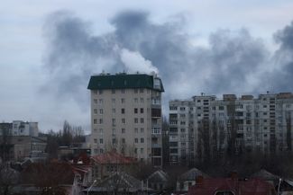 Smoke rises over the city from a fire at a Luhansk oil depot caused by shelling. Luhansk, March 7, 2022.