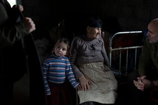 Elena, an elderly resident of Goraki village, with her relatives