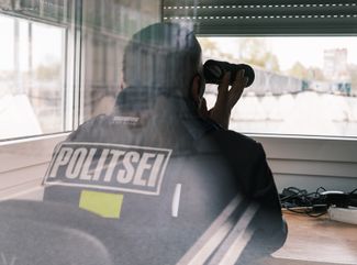 Estonian border guards at the checkpoint on the Friendship Bridge over the Narva River. After the Russian invasion of Ukraine, the checkpoint on the Friendship Bridge was closed to vehicles; Now it is only open to pedestrians.