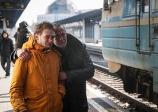 Отец и сын перед отправлением эвакуационного поезда, на котором уезжают их родственники. Поезд едет во Львов из Киева