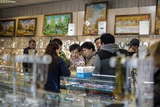 Tourists from China look at amber in a store in Moscow