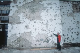 Traces of the fighting on a wall in Bosnia. 1994.