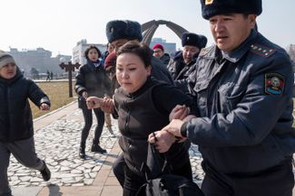 An officer arrests Altyn Kapalova during an International Women’s Day march in Bishkek. March 8, 2020.