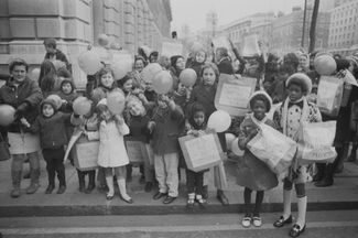 School children and parents with posters 