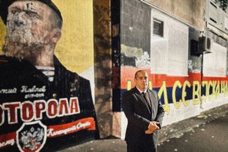 Misa Vacic poses with a mural devoted to Arsen “Motorola” Pavlov