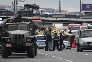 Military vehicles and police on a highway in the Moscow region.