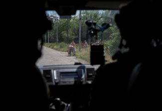 Police officers from the White Angels unit, responsible for the evacuation of civilians in Drozhkovka, Donetsk region. The city found itself dangerously close to the front line 