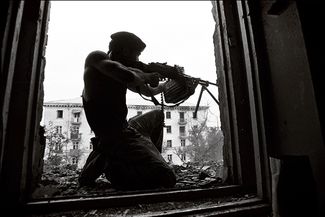 Чеченский боец обстреливает позиции российских войск. Август 1996 года