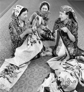 A Dungan woman embroiders her wedding dress with her mother and grandmother. Chüy Valley, Kazakhstan, 1989.
