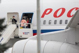 Российские дипломаты и члены их семей садятся в самолет специального летного отряда «Россия» в аэропорту Праги, 19 апреля 2021 года