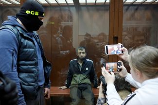 Shamsidin Fariduni in court. Footage appeared on Telegram over the weekend that appears to show Russian security forces torturing Fariduni by electrocuting his genitals.