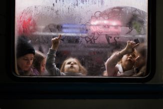 Children draw pictures on a train car window at the Lviv train station. Lviv has become the main transit point for refugees on their way to Europe; most are headed to Poland. March 2, 2022