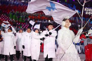 Сборные Северной и Южной Корей шли под единым флагом. Спортсмены из двух сборных несли его вместе