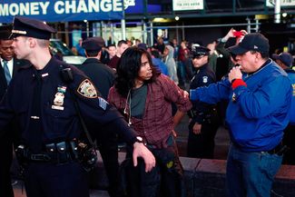 Полиция задерживает демонстранта в Нью-Йорке.