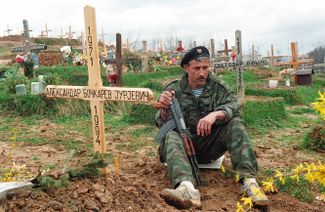 Российский доброволец, приехавший на боснийскую войну, сидит на могиле погибшего друга. Через месяц его похоронят рядом. Июнь 1994 года